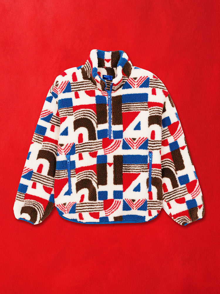 A flat product image of a fleece half zip pullover featuring a multi color print against a red background.