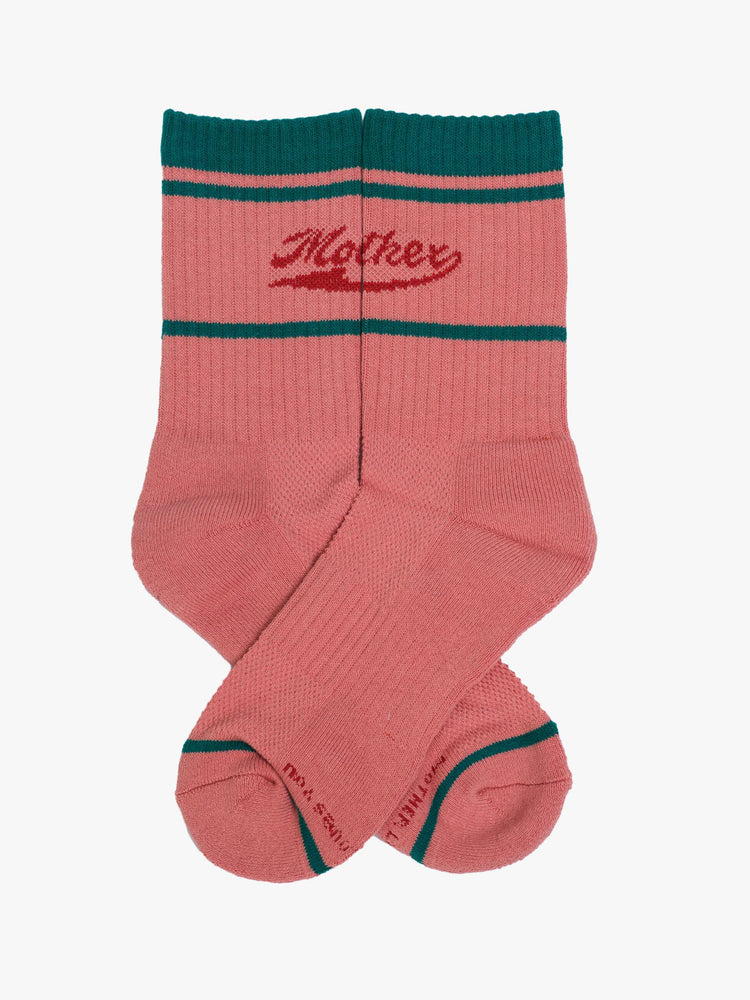 Flat view of coral pink socks with red lettering and green details.