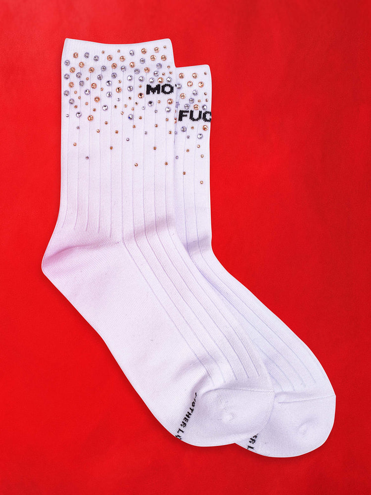 A flat image of a pair of white socks with embellished stones against a red background.