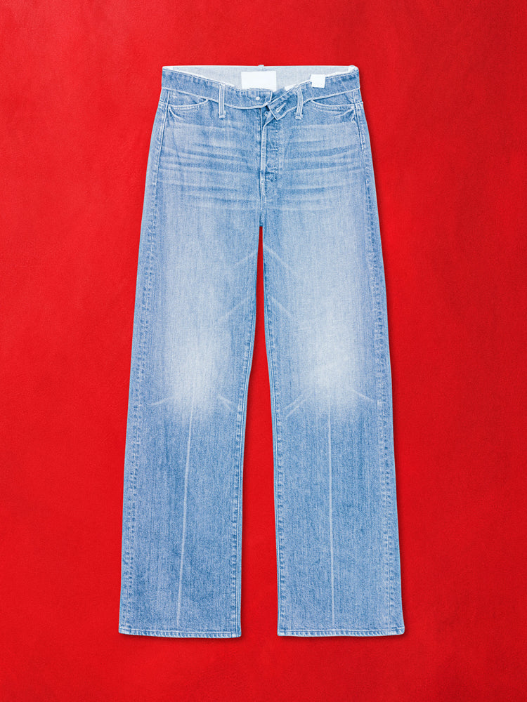 A flat product image of a pair a blue denim jeans against a red background.