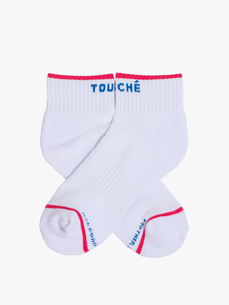 Side flat view of ankle length tube socks in oatmeal with navy text and red details.