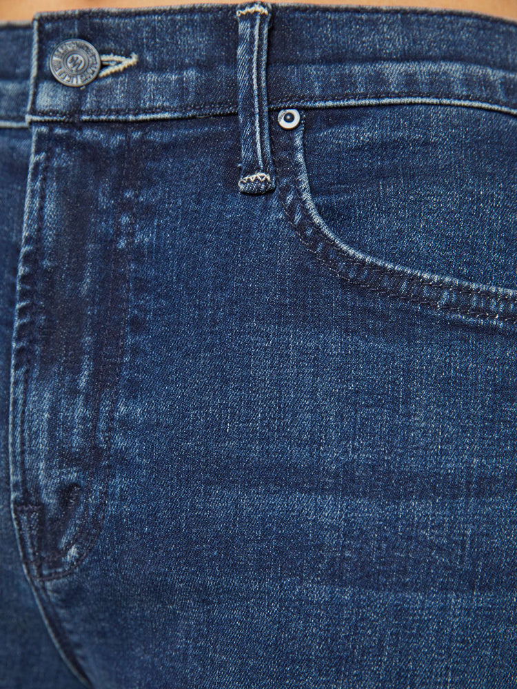 Swatch view of a petites woman in a dark blue high-rise straight leg jean with a 30-inch inseam and a clean hem.