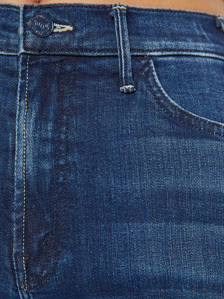 Swatch view of a petite woman in a dark blue wide leg jeans  with a high rise, 30-inch inseam and a clean hem.