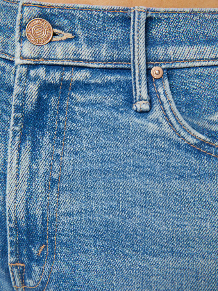 Swatch view of a petite woman in a light blue mid rise flare jean.