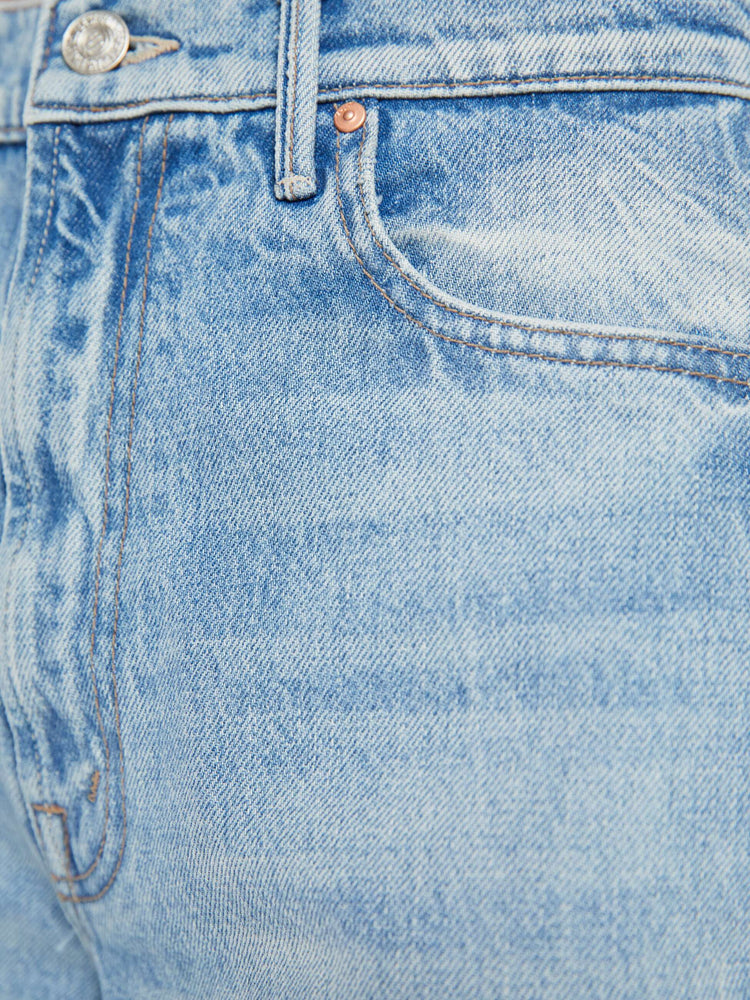 Swatch view of a high rise wide leg jean in a light blue wash with printed pattern down the side of each leg.