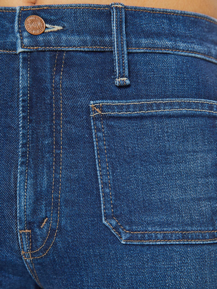 Swatch view of a petite woman in a dark blue high-waisted jeans with a wide straight leg, zip fly, patch pockets and a long 30-inch inseam with a clean hem. 