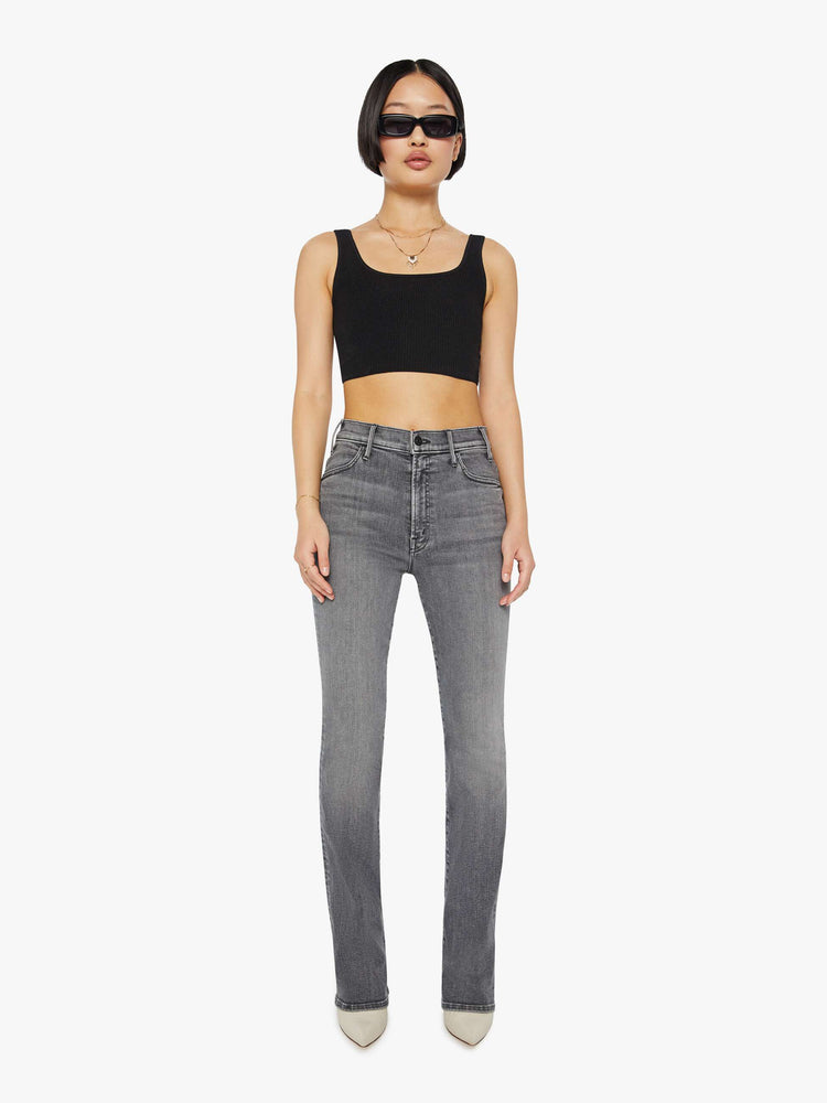 Front view of a woman in a grey High-waisted flare jeans with a longer inseam and a clean hem.