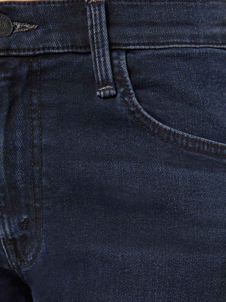 Swatch view of a petite woman in a dark denim mid-rise jean with a wide straight leg, zip fly and clean ankle-length inseam.