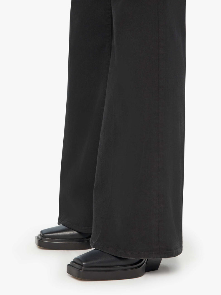 Swatch view of a woman in a black wide-leg jean with a high rise and a clean, 30-inch inseam.