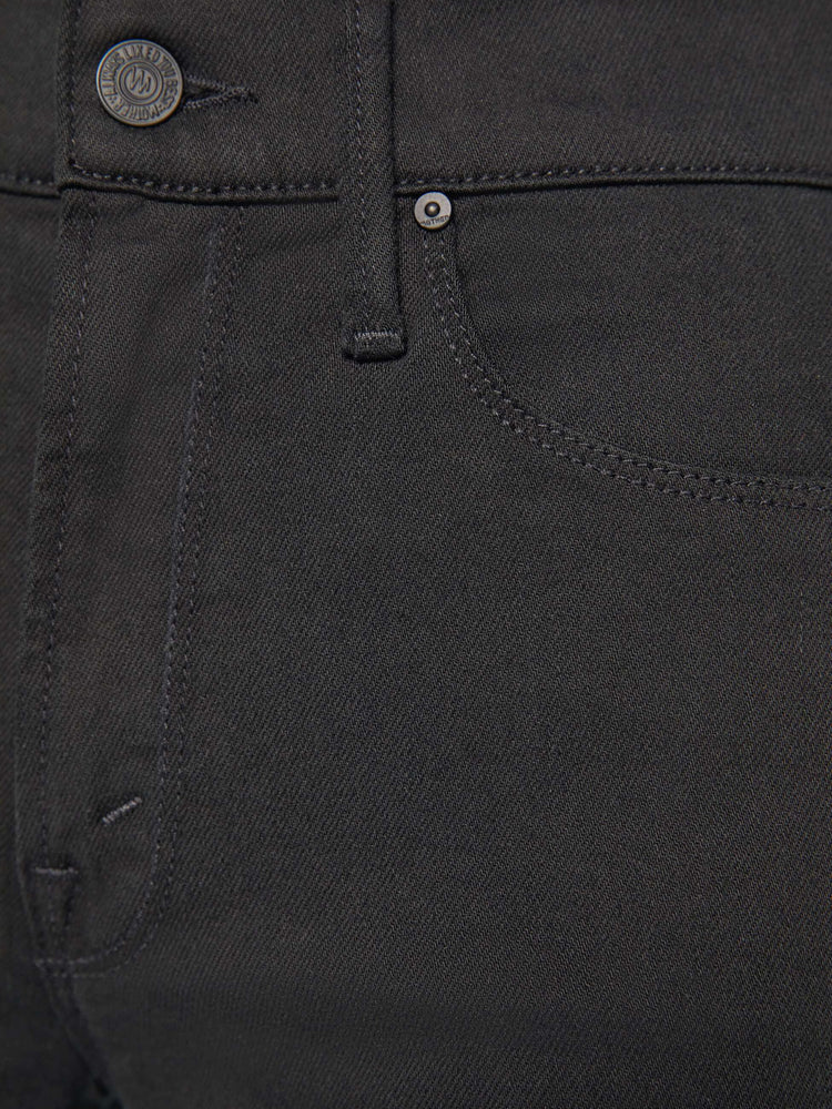 Detailed view of a woman in a black wide-leg jean with a high rise and a clean, 30-inch inseam.