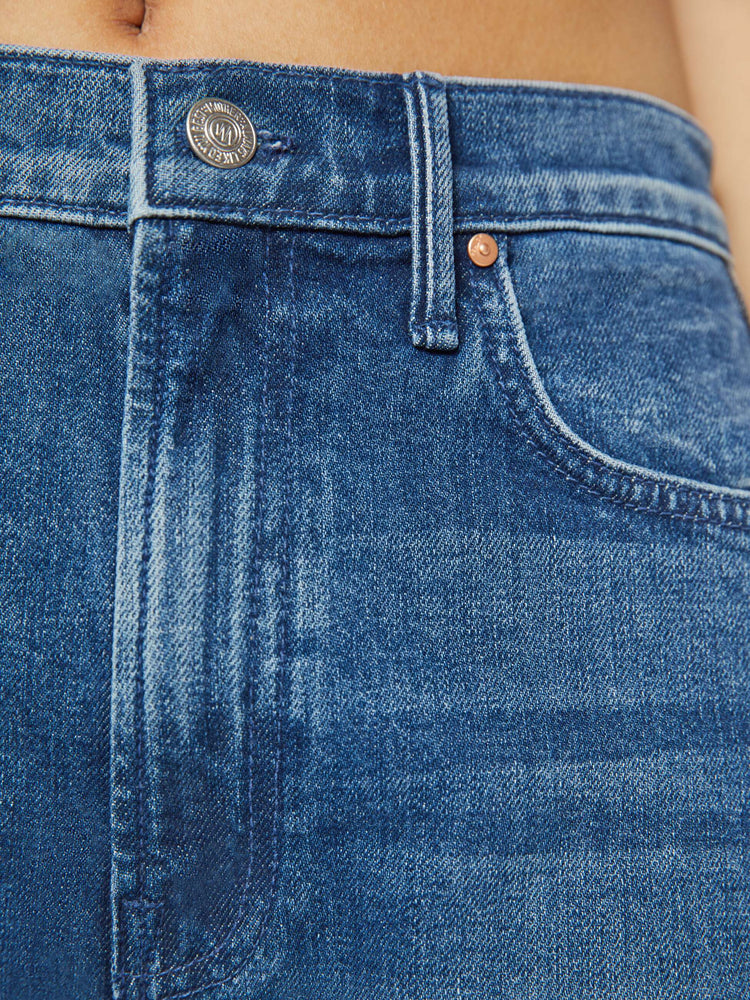 Swatch view of a petites woman in a black and blue super high-waisted jean with a wide, curved leg, a 26.25-inch inseam and a clean hem.