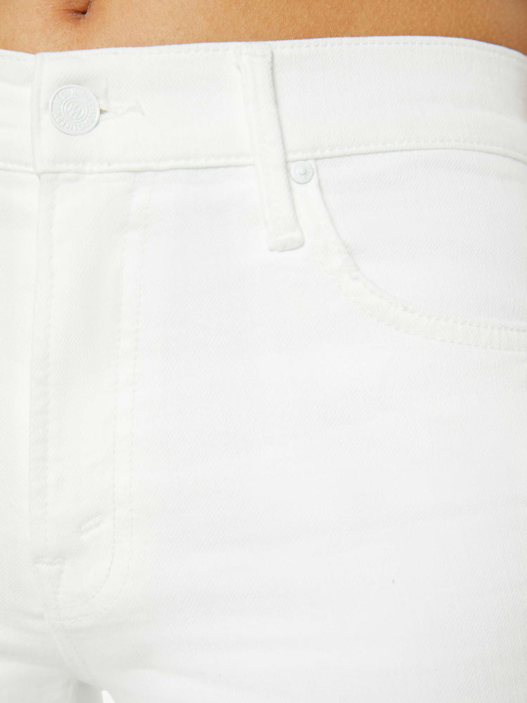 Swatch view of a petites woman high-waisted bootcut is cropped at the ankle with a frayed step-hem in a white wash.