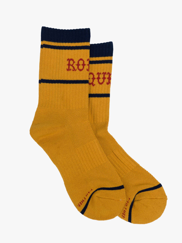 Side flat view of a yellow socks with red lettering that reads "Rodeo Queen" and navy details.