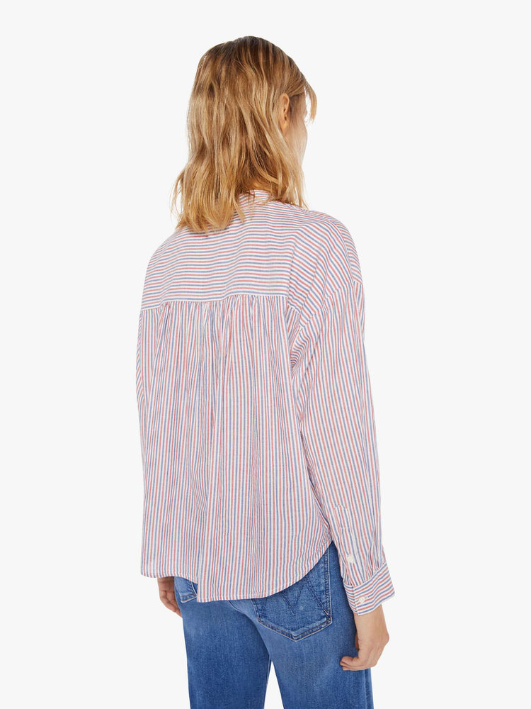 Back view of a woman's long sleeve button up shirt with red, white, and blue stripes