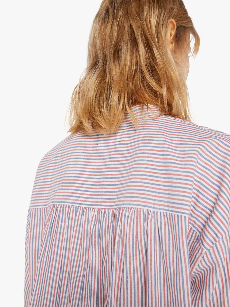 Back detail view of a woman's long sleeve button up shirt with red, white, and blue stripes