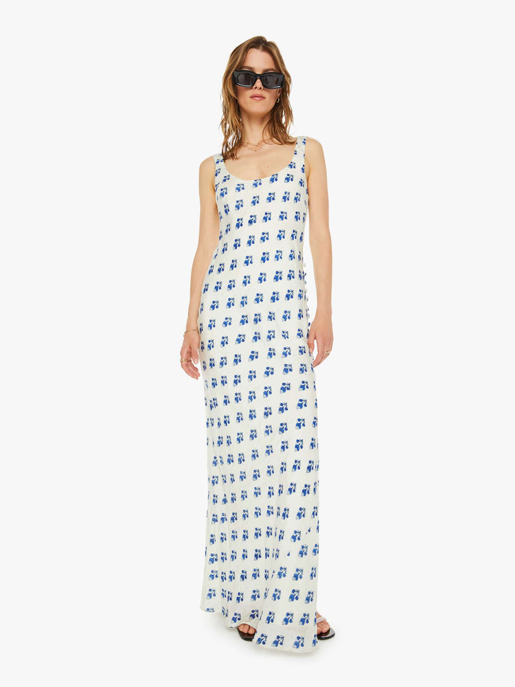 Front view of a woman slip dress in white with a blue porcelain-inspired print, and features a scoop neck, narrow fit and an ankle-length hem.