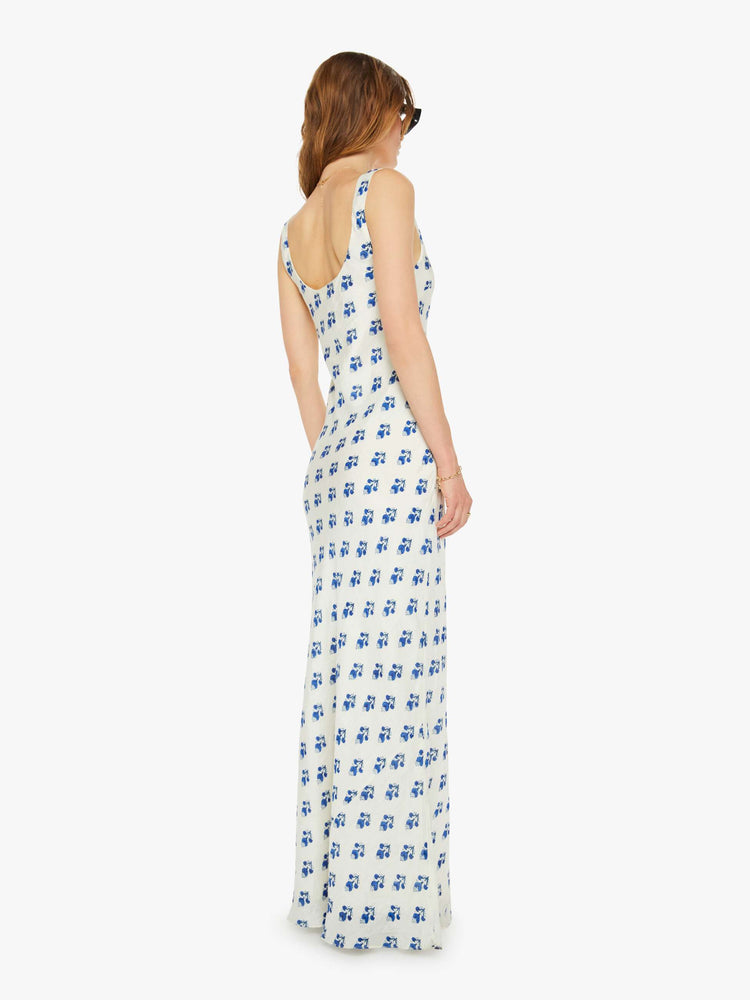 Back view of a woman slip dress in white with a blue porcelain-inspired print, and features a scoop neck, narrow fit and an ankle-length hem.