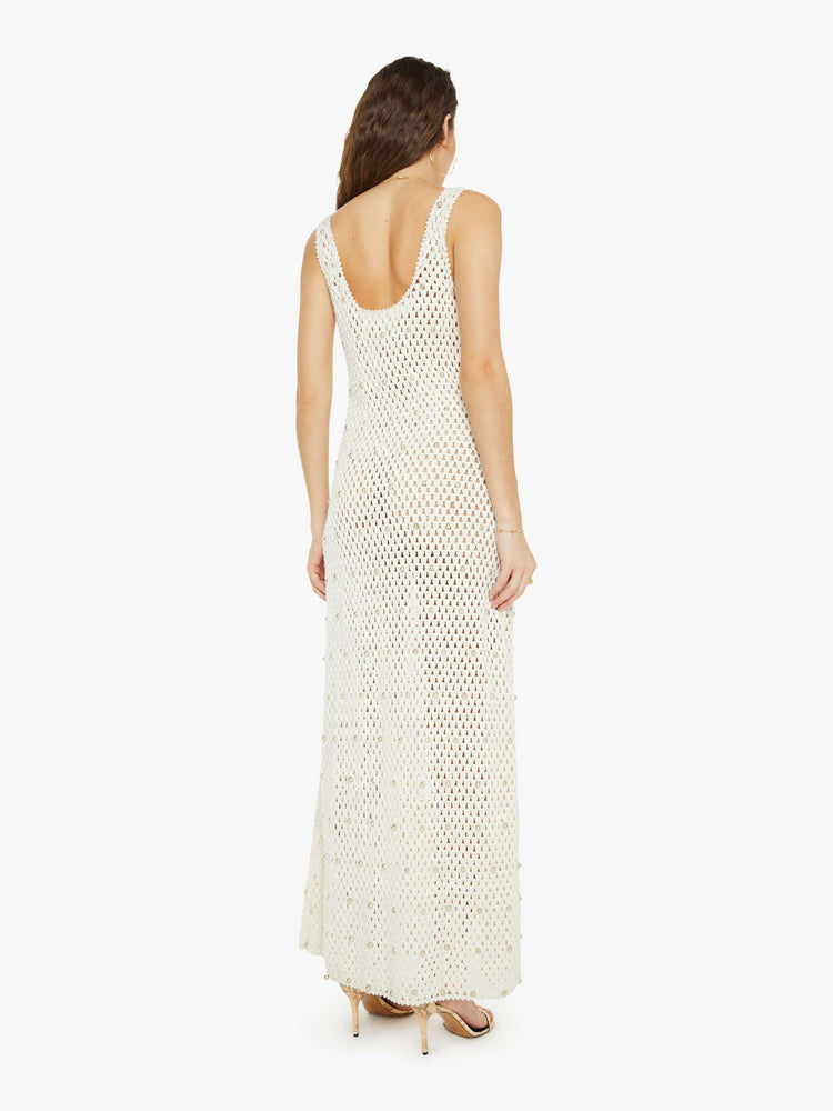 Back view of a woman sleeveless dress is made from 100% cotton in ivory, and features a scoop neck, narrow fit, an ankle-length hem and pearl embellishments throughout.