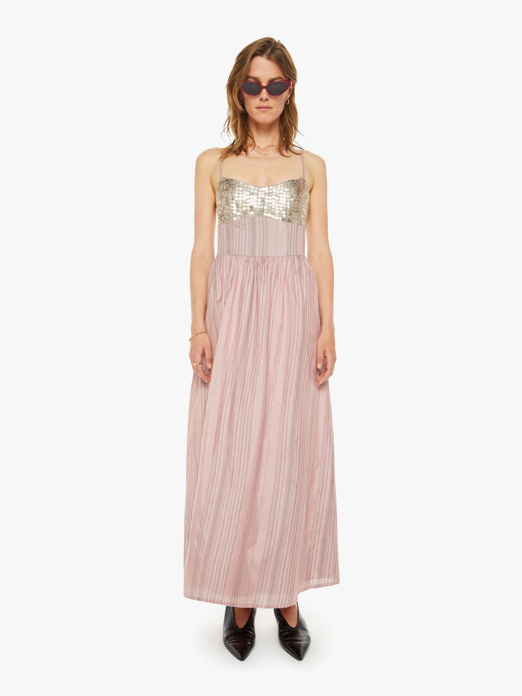 Front view of a woman formal midi dress in mauve, and features a V-neck, thin spaghetti straps, a fitted bodice with coin embellishments, and a loose, flowy skirt that hits at the calf.