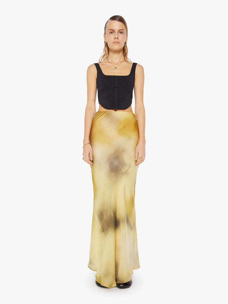 Front view of a woman maxi skirt features a super high rise and an A-line fit with an ankle-length hem in a watercolor -inspired blend of cream, yellow and charcoal.