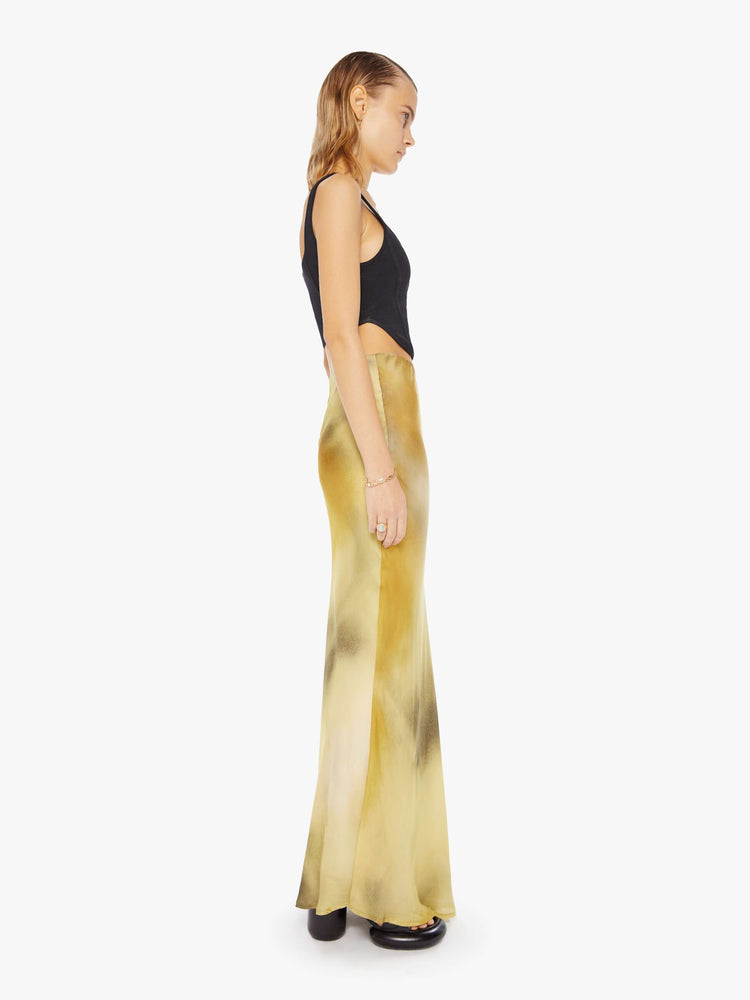 Side view of a woman maxi skirt features a super high rise and an A-line fit with an ankle-length hem in a watercolor -inspired blend of cream, yellow and charcoal.