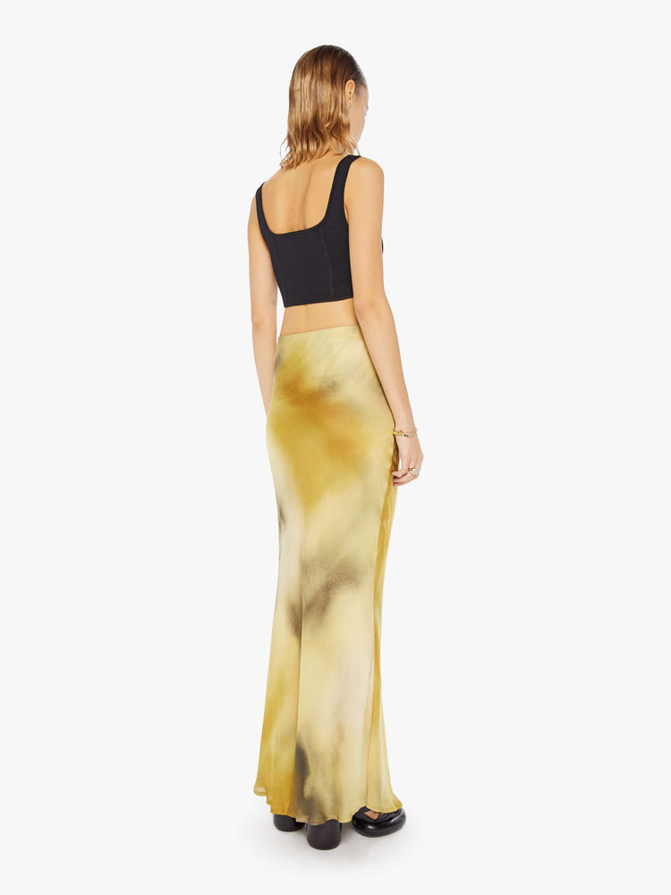 Back view of a woman maxi skirt features a super high rise and an A-line fit with an ankle-length hem in a watercolor -inspired blend of cream, yellow and charcoal.