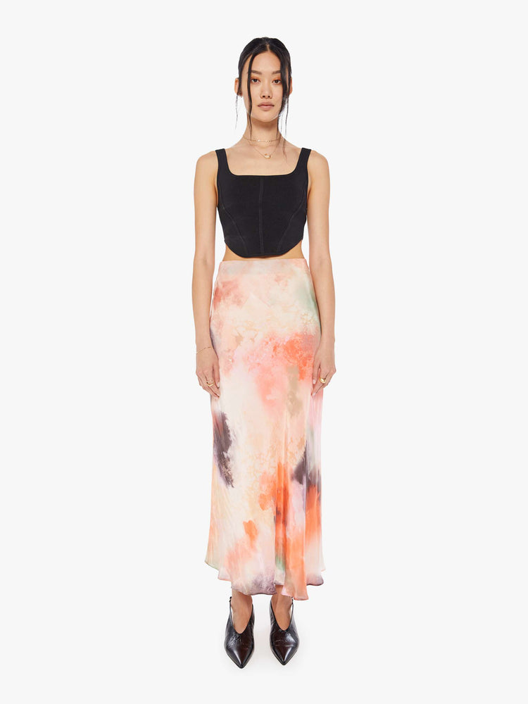 Front view of a woman water color inspired maxi skirt with a super high rise and an A-line fit with an ankle-length hem.