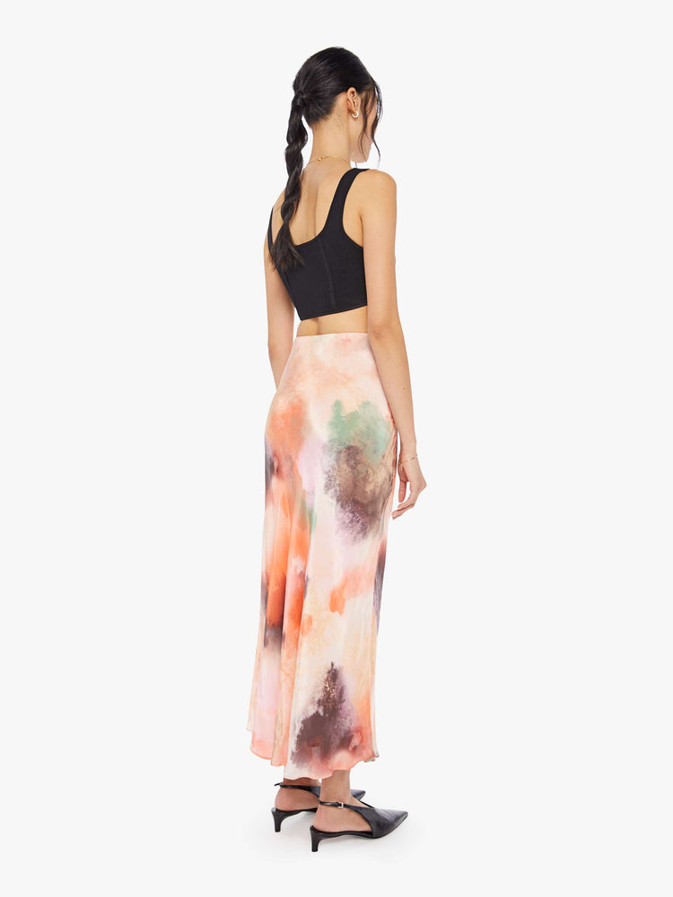 Back view of a woman water color inspired maxi skirt with a super high rise and an A-line fit with an ankle-length hem.