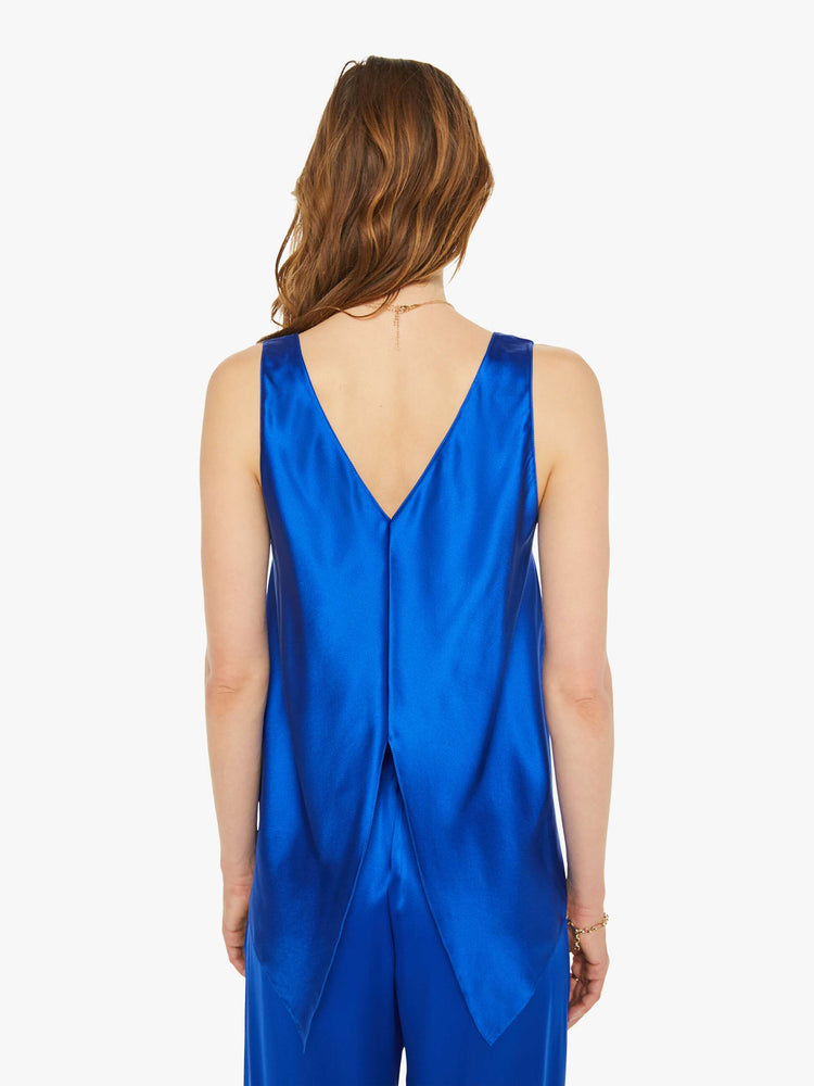 Back view of a woman in a royal blue scoop tank with thick straps and a loose, flowy fit.