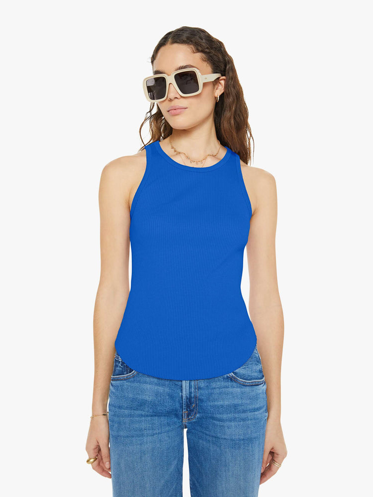 Front view of a woman in a blue tank top with a scoop neck, slim fit and hip-grazing hem.