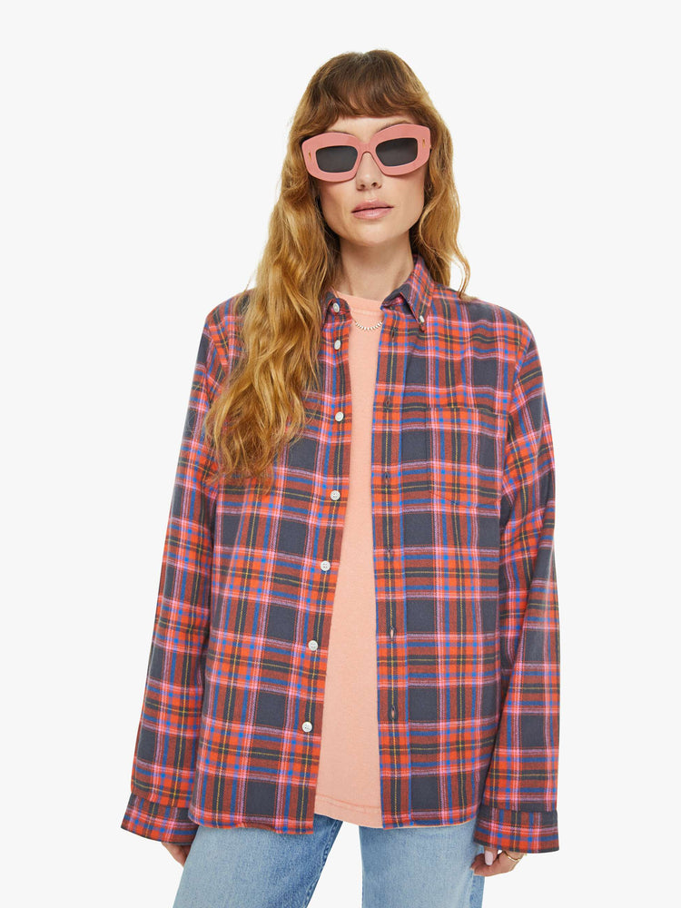 Front view of a woman long sleeve button-up shirt in a pink and navy checkered print, and is designed with a patch pocket and loose, boxy fit.