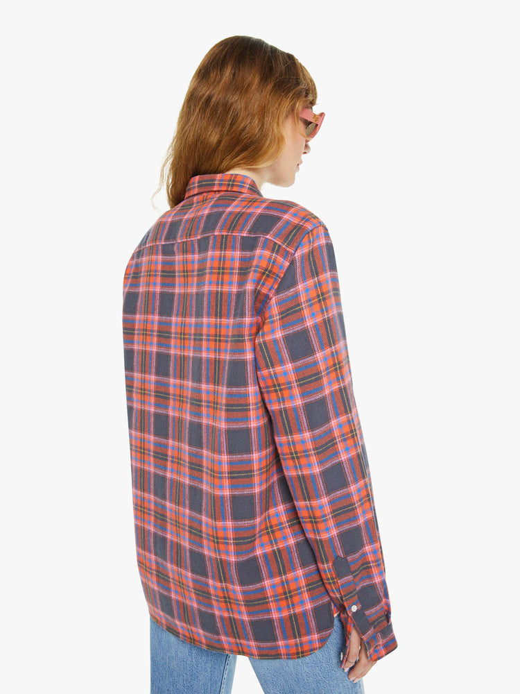 Back view of a woman long sleeve button-up shirt in a pink and navy checkered print, and is designed with a patch pocket and loose, boxy fit.