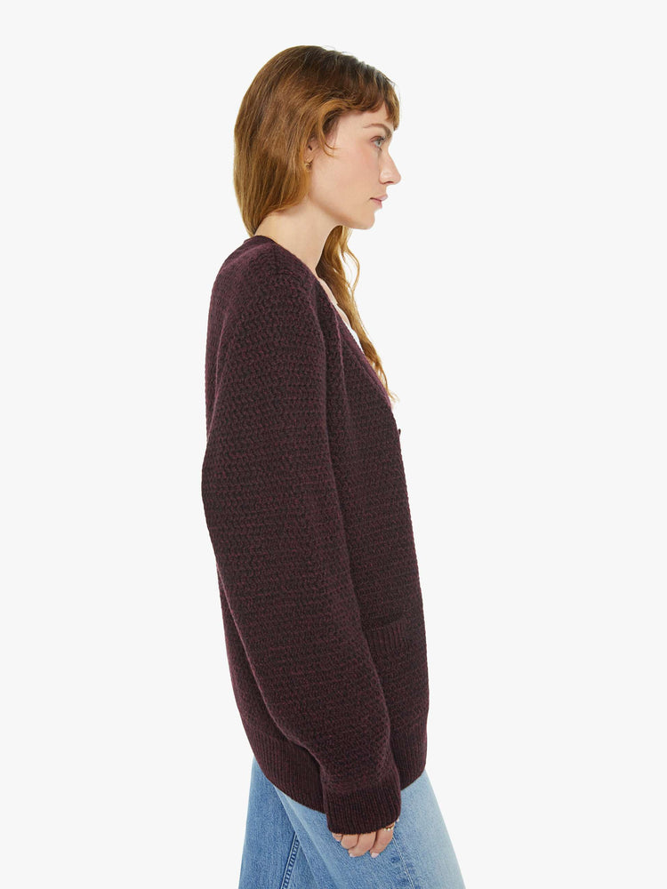 WOMAN side view in dark maroon vneck cardigan.