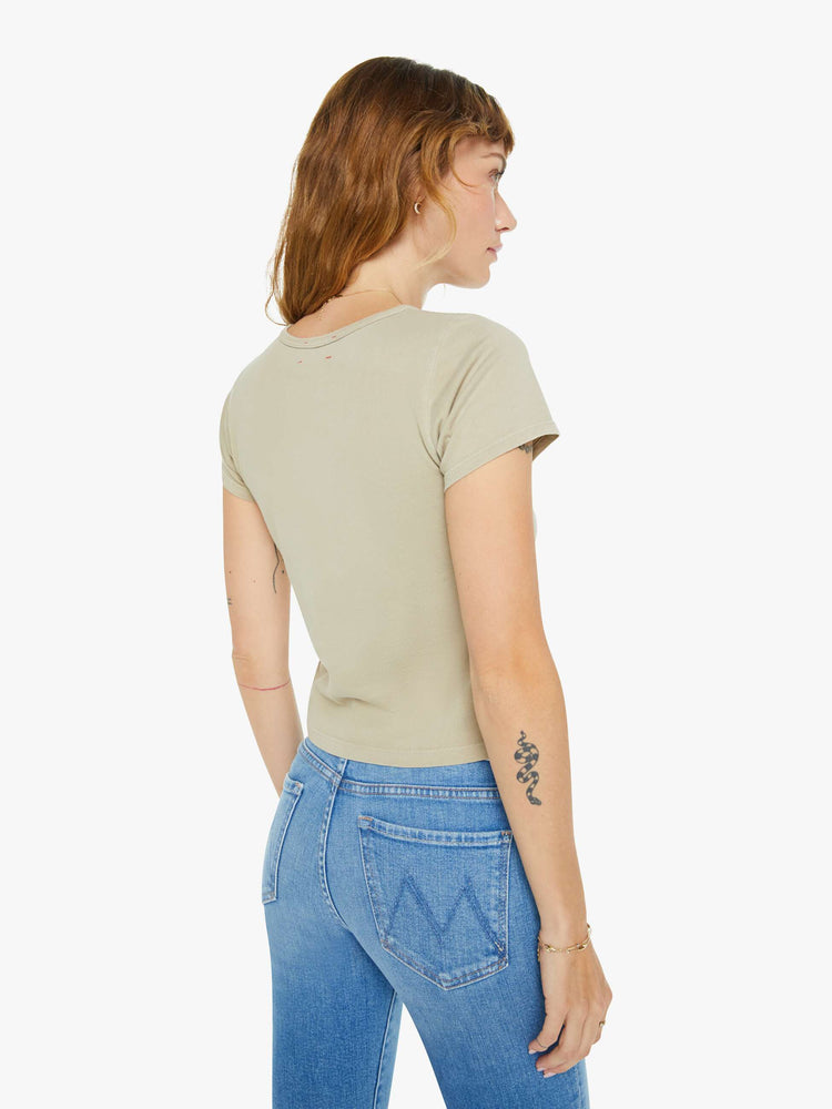 Back view of a woman in taupe tee with a cropped hem and shrunken fit.