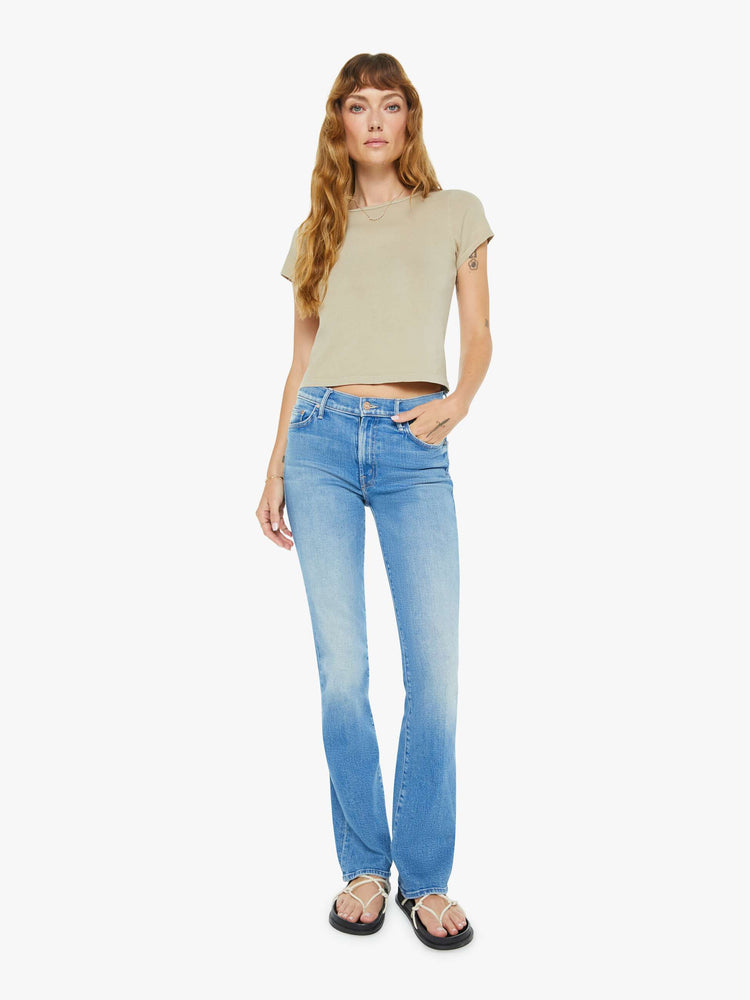 Full body view of a woman in taupe tee with a cropped hem and shrunken fit.