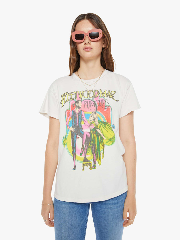 Front view of a woman in crewneck tee white, the tee pays homage to Fleetwood Mac's Rumours album with a graphic portrait on the front.