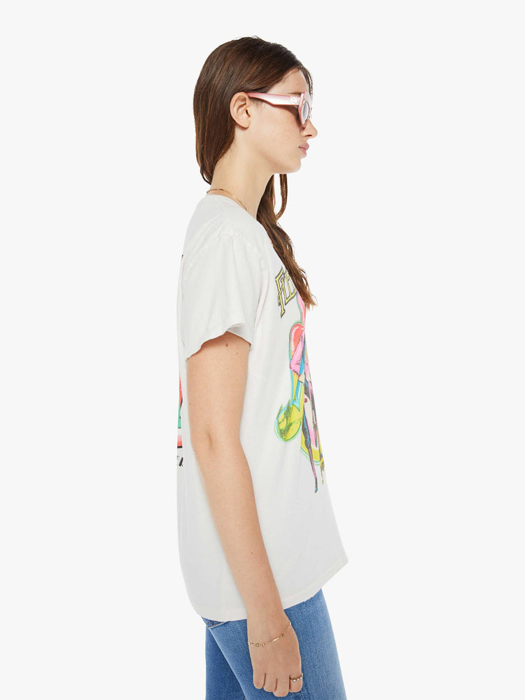 Side view of a woman in crewneck tee white, the tee pays homage to Fleetwood Mac's Rumours album with a graphic portrait on the front.