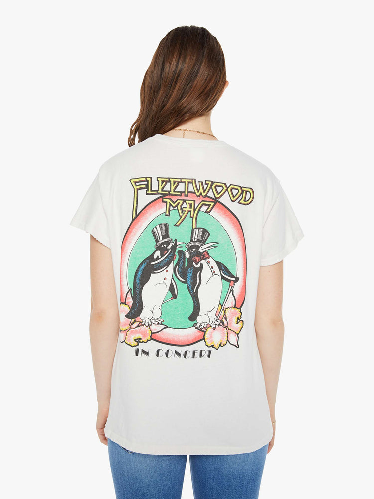 Back view of a woman in crewneck tee white, the tee pays homage to Fleetwood Mac's Rumours album with a graphic portrait on the front.