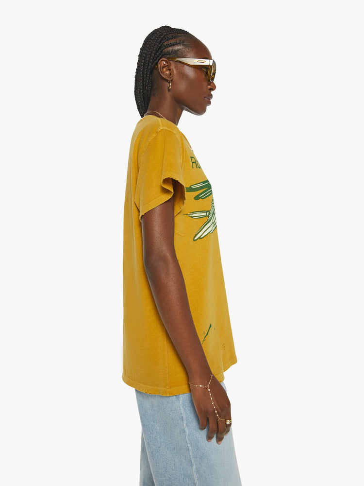 Side view of a mustard yellow crew neck tee featuring a Rolling Stones graphic.