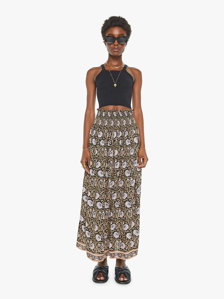 Front view of a black floral print maxi shirt with a smocked waistband and a loose, flowy fit.