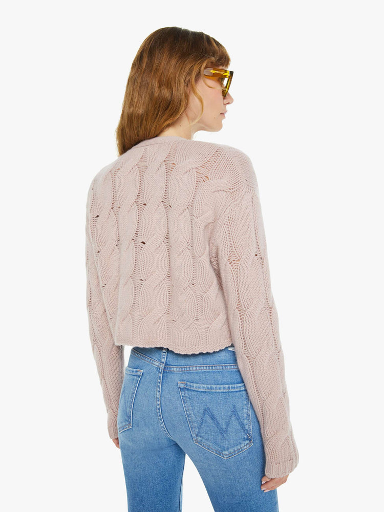 Back view of a woman in deep V-neck, drop shoulders, ribbed hems and a slightly cropped fit cardigan in a dusty pink.