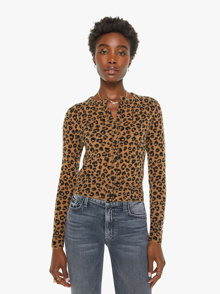 Front view of a woman in a leopard print cardigan.