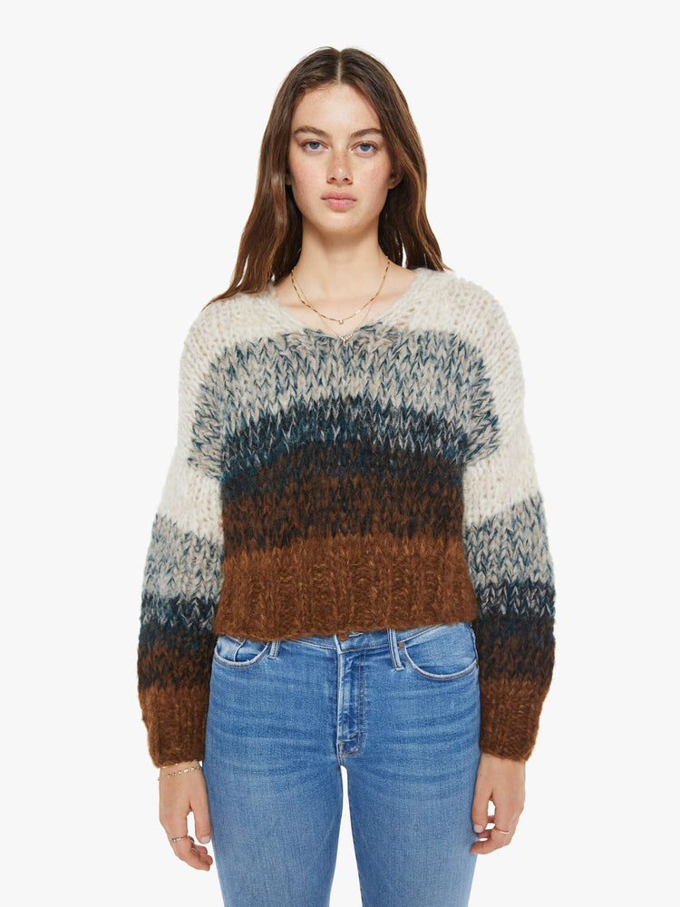 Front view of a woman sweater is hand knit from a soft alpaca blend in a brown, grey and cream ombre design.