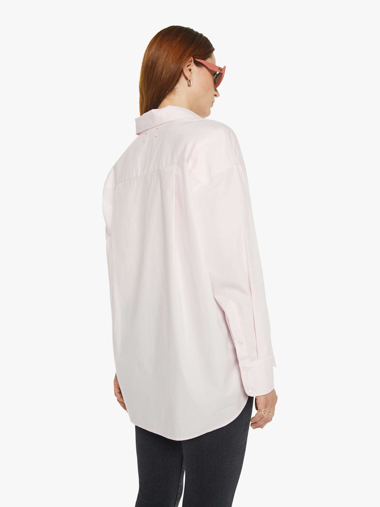 WOMAN back view of a woman in light pink oversized button-up blouse with drop shoulders, a front patch pocket, curved hem and a loose fit.