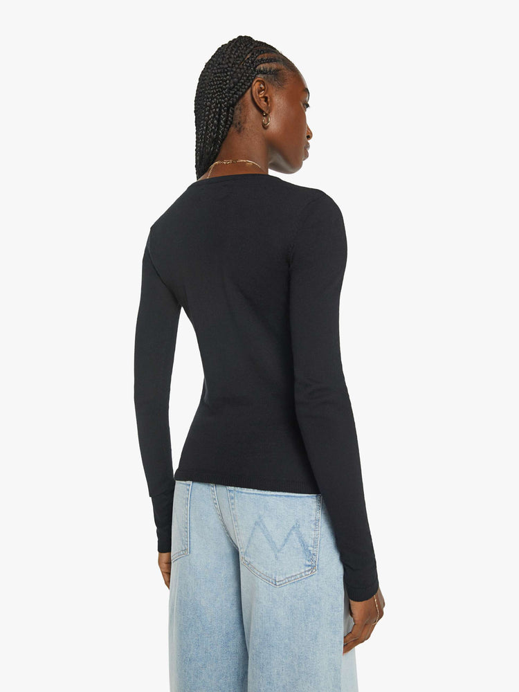 Back view of a womans in a long sleeve sweater in black with a high crew neck and a narrow fit.