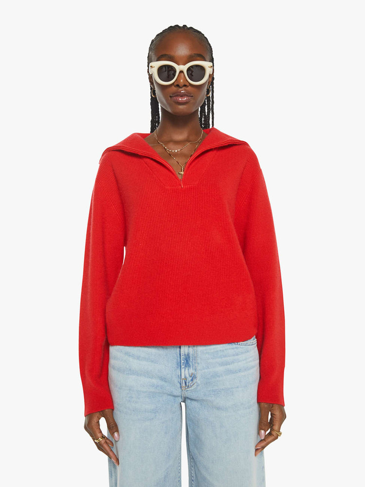 WOMAN Front view of a woman in a red sweater with a V-neck that zips, drop shoulders and a loose fit.