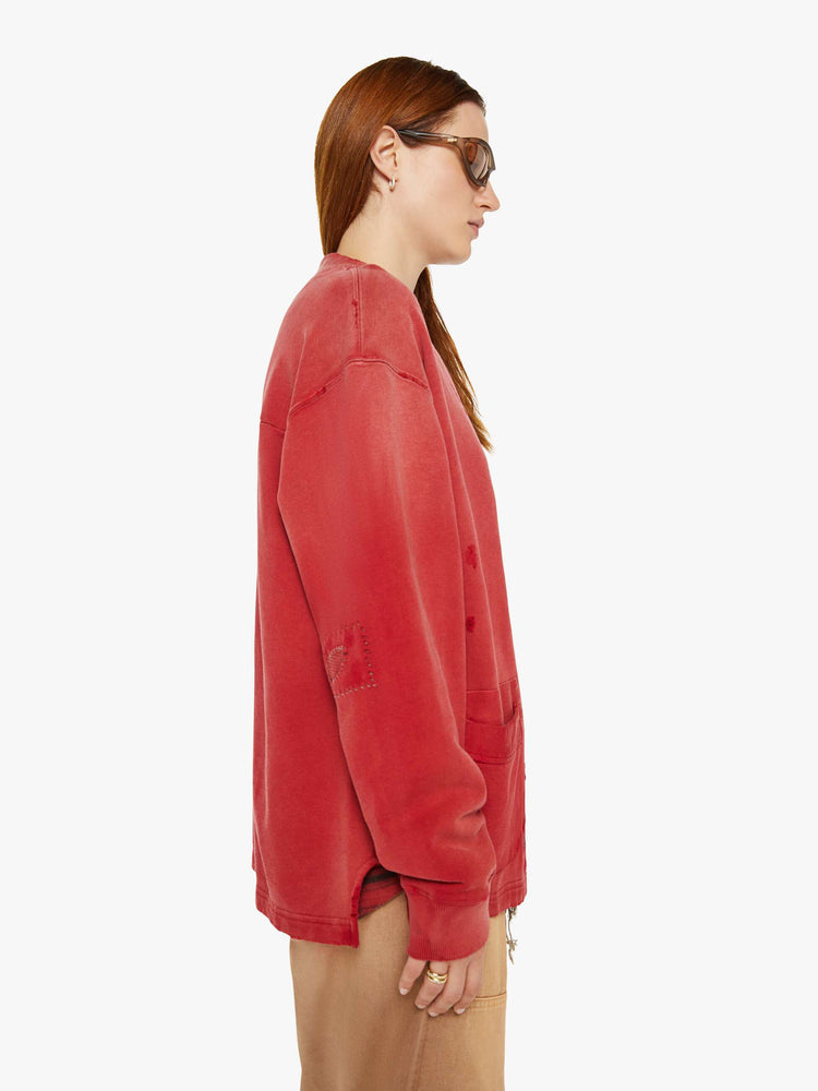 WOMAN side view in a V-neck, drop shoulders, patch pockets and ribbed hems red cardigan.