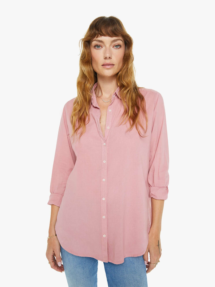 Front view of a woman in a rose pink button-down.