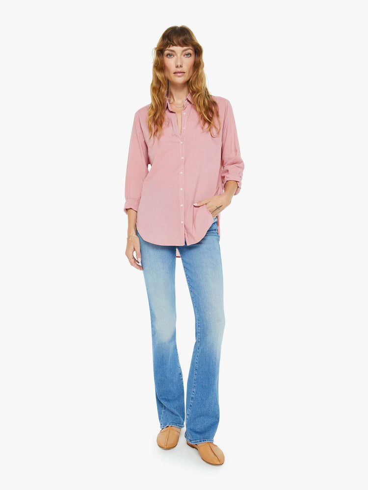 Full body view of a woman in a rose pink button-down.