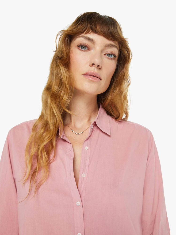 Close up view of a woman in a rose pink button-down.